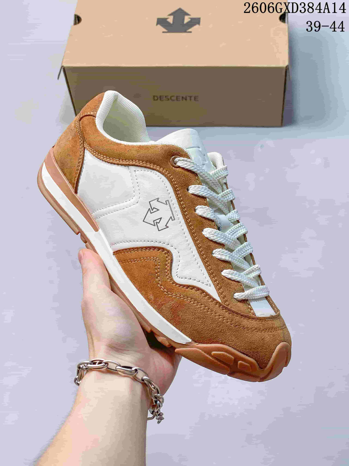 Side view of a brown and white Descente low-top sneaker