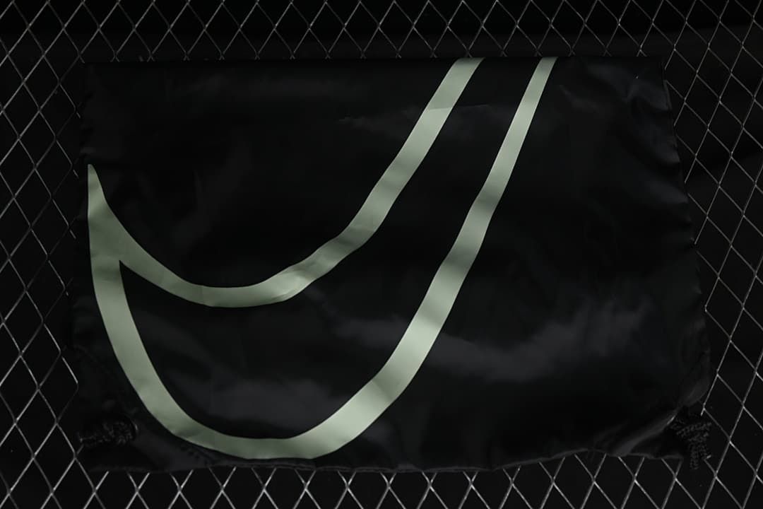 Black Nike-branded fabric bag with a large Swoosh graphic