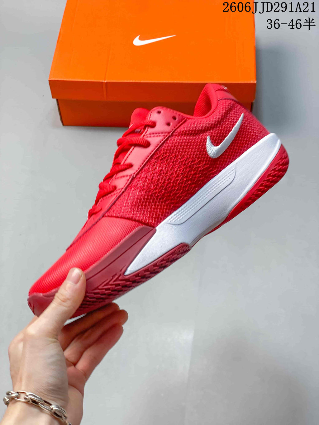 Side view of the red shoe showing its white Swoosh, midsole, and textured upper.