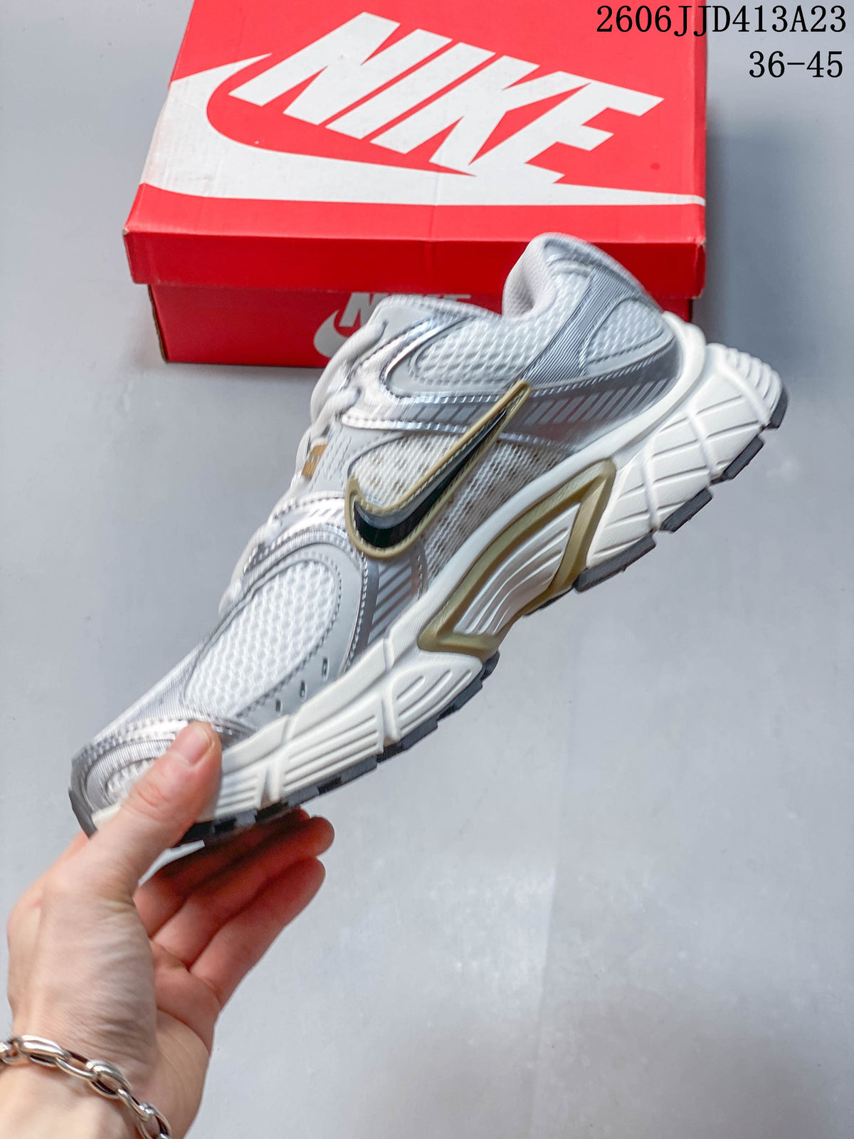 Side view highlighting the layered upper, side logo and sculpted sole