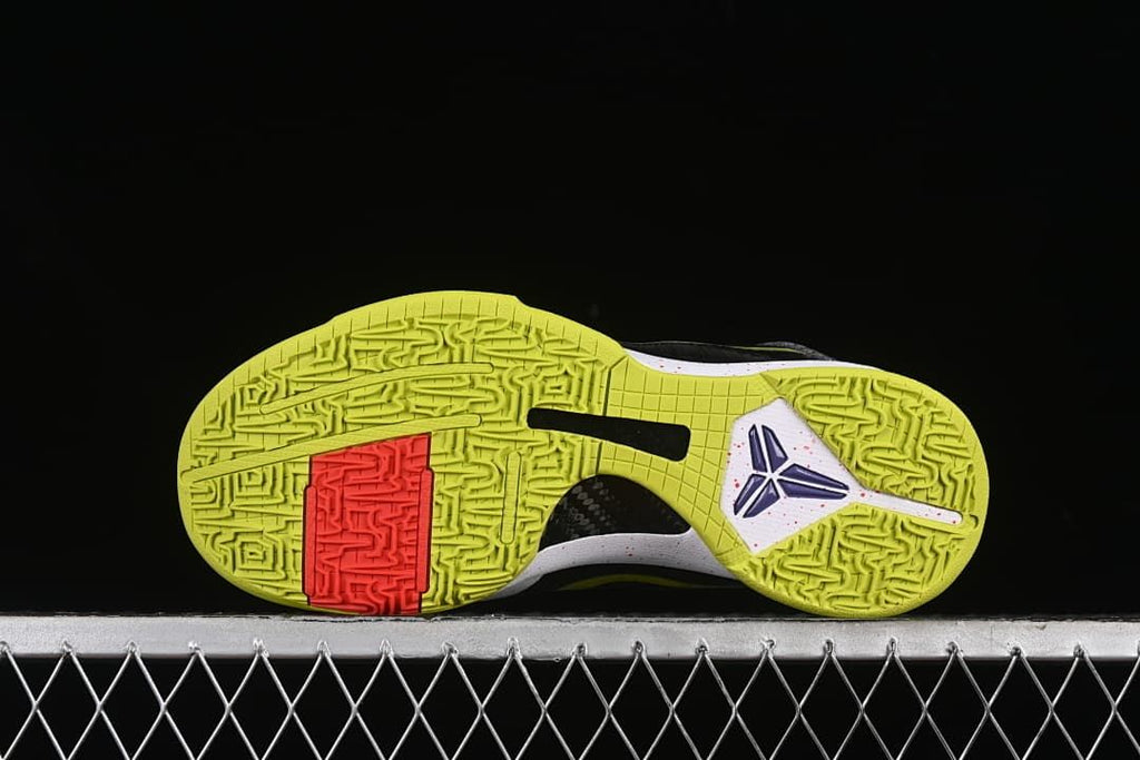 Full outsole view with yellow-green tread and a contrasting red section.