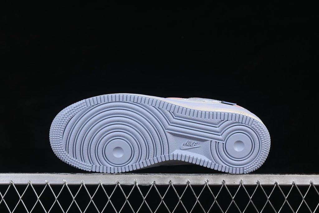 Underside view showing the circular-patterned pale blue outsole