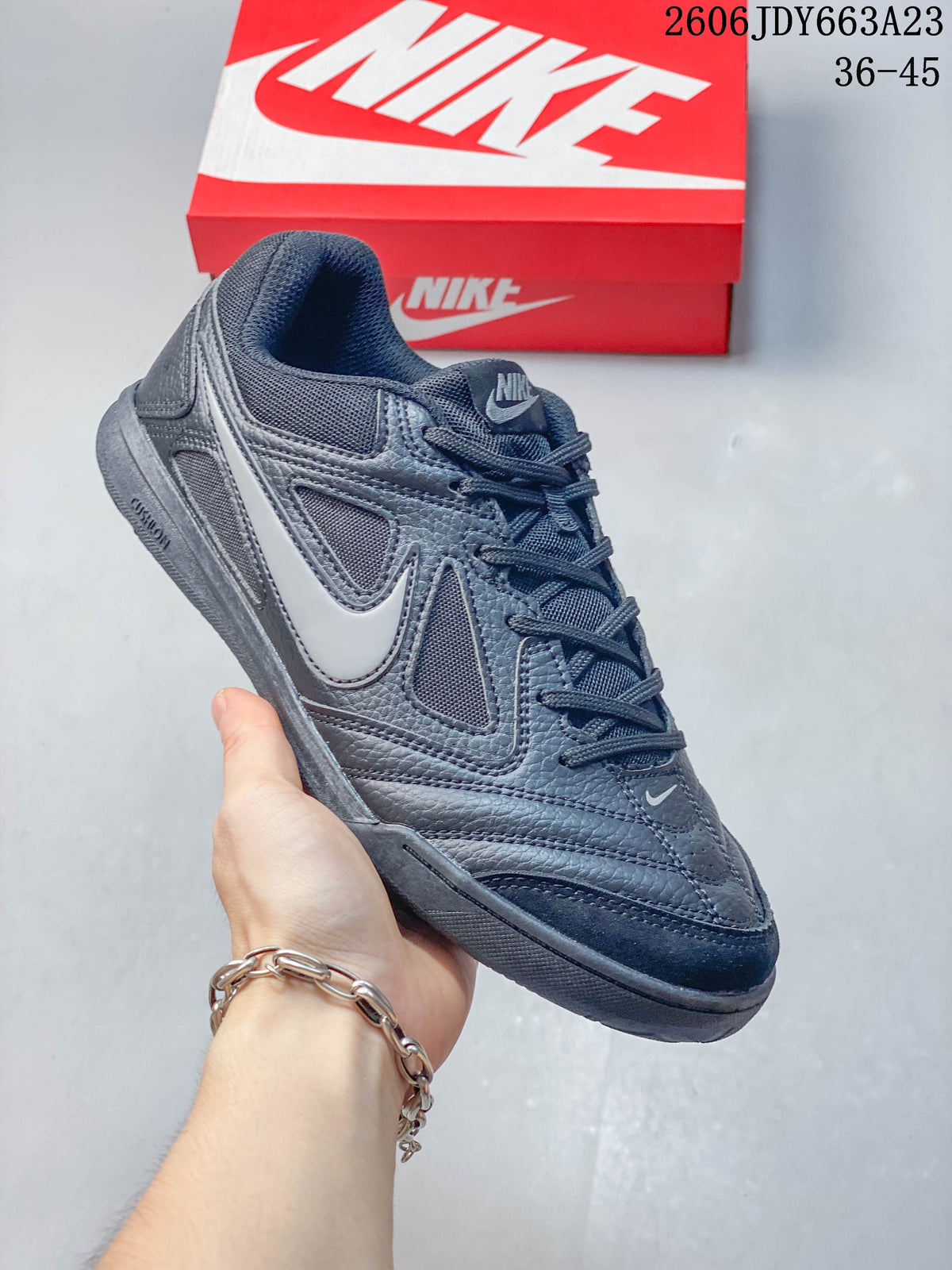 Close-up of a dark gray Nike Gato sneaker with white side accent and dark outsole