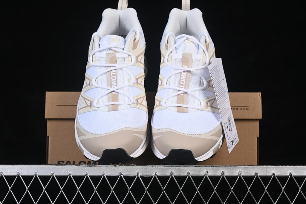 Front view of the pair of white and tan sneakers.
