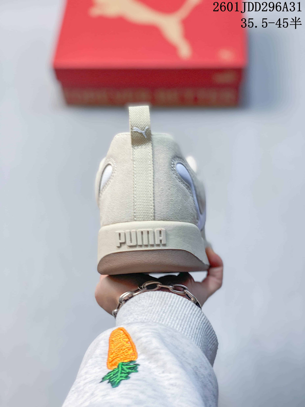 Rear view of a cream PUMA sneaker with a branded heel and pull tab