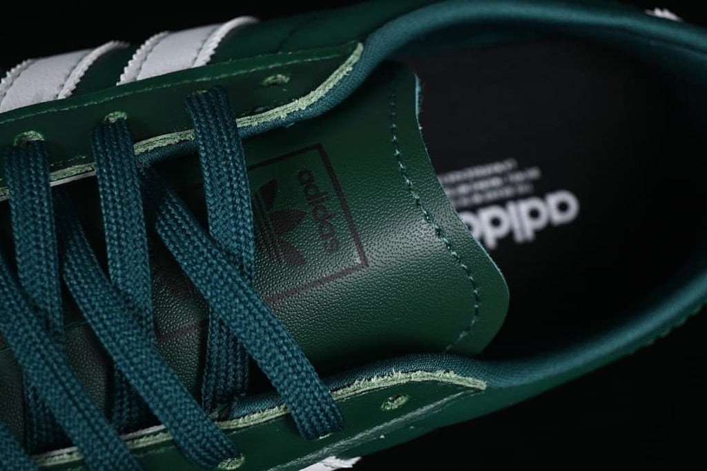 Close-up of the green laces, eyelets and tongue branding.