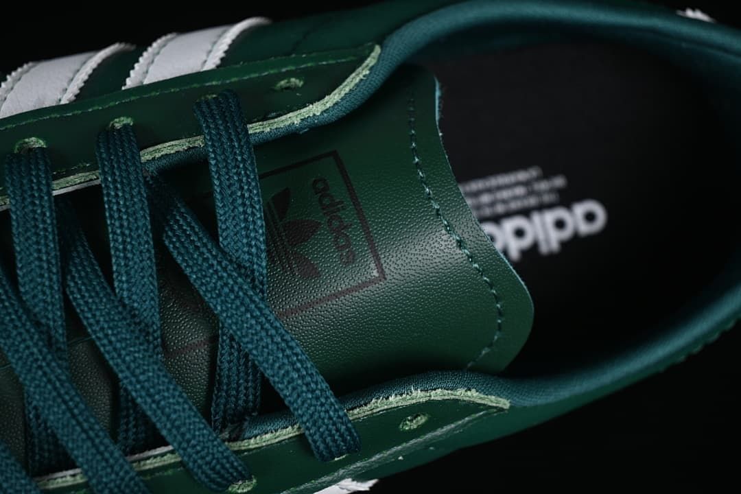 Close-up of the green laces, eyelets and tongue branding.