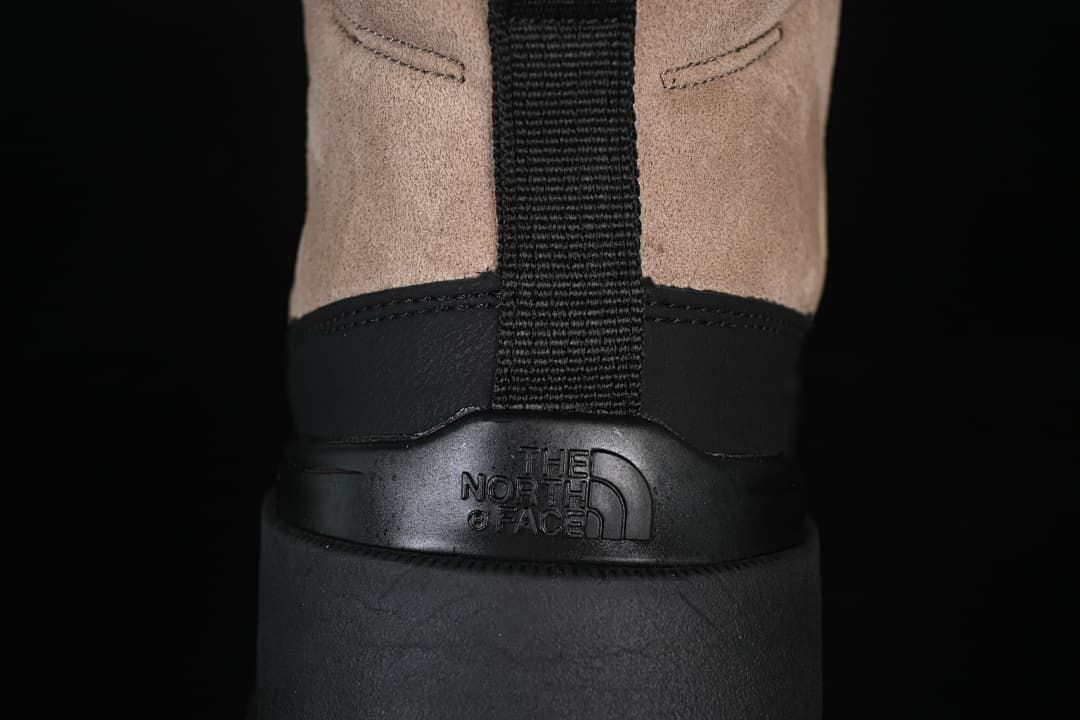 Rear view showing the boot's pull tab, heel overlay, and embossed branding
