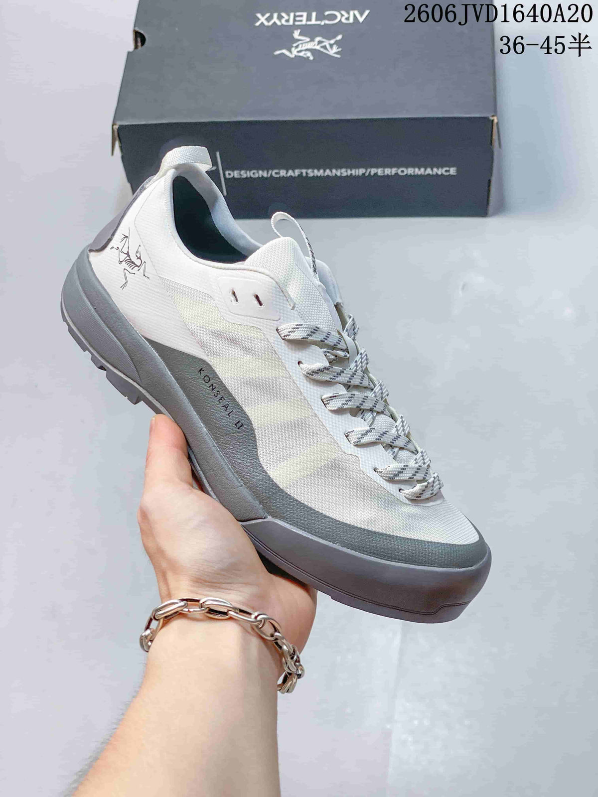 White and gray Arc'teryx Konseal LT trail shoe shown from the side.