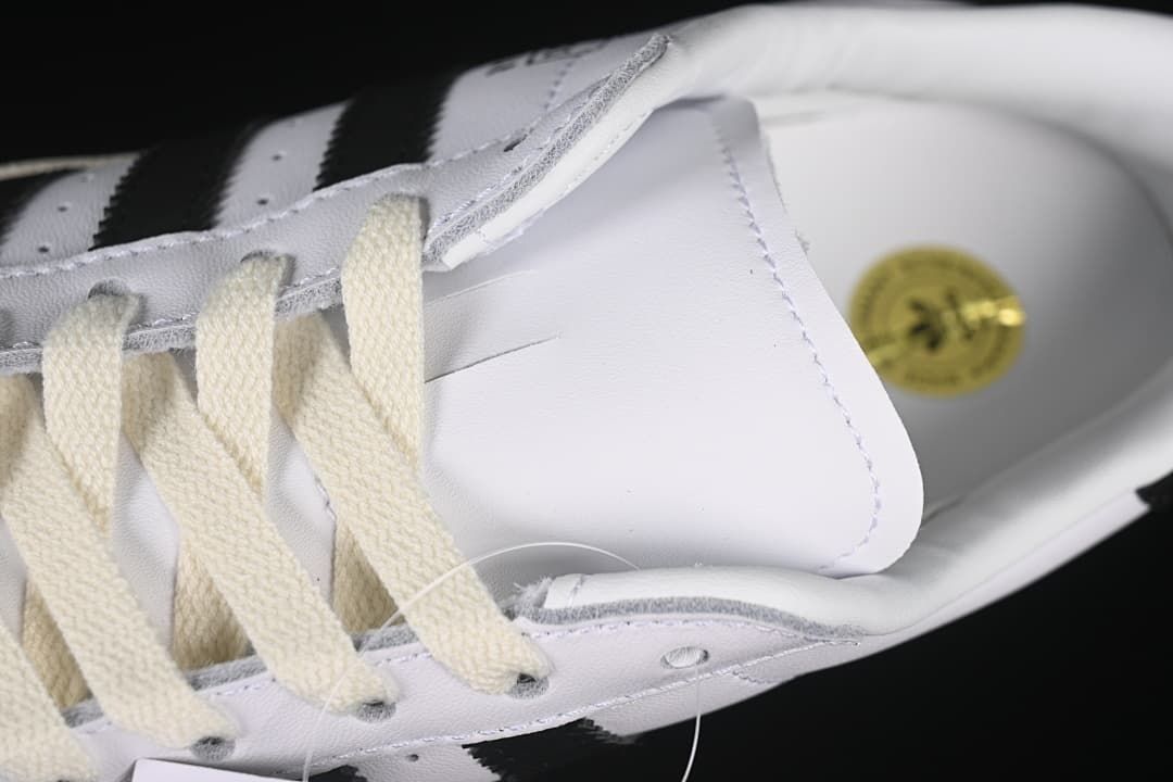 Close-up of cream laces and white sneaker upper