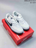 Pair of white Nike Terra Manta sneakers with dark gray accents, shown on a red shoe box.