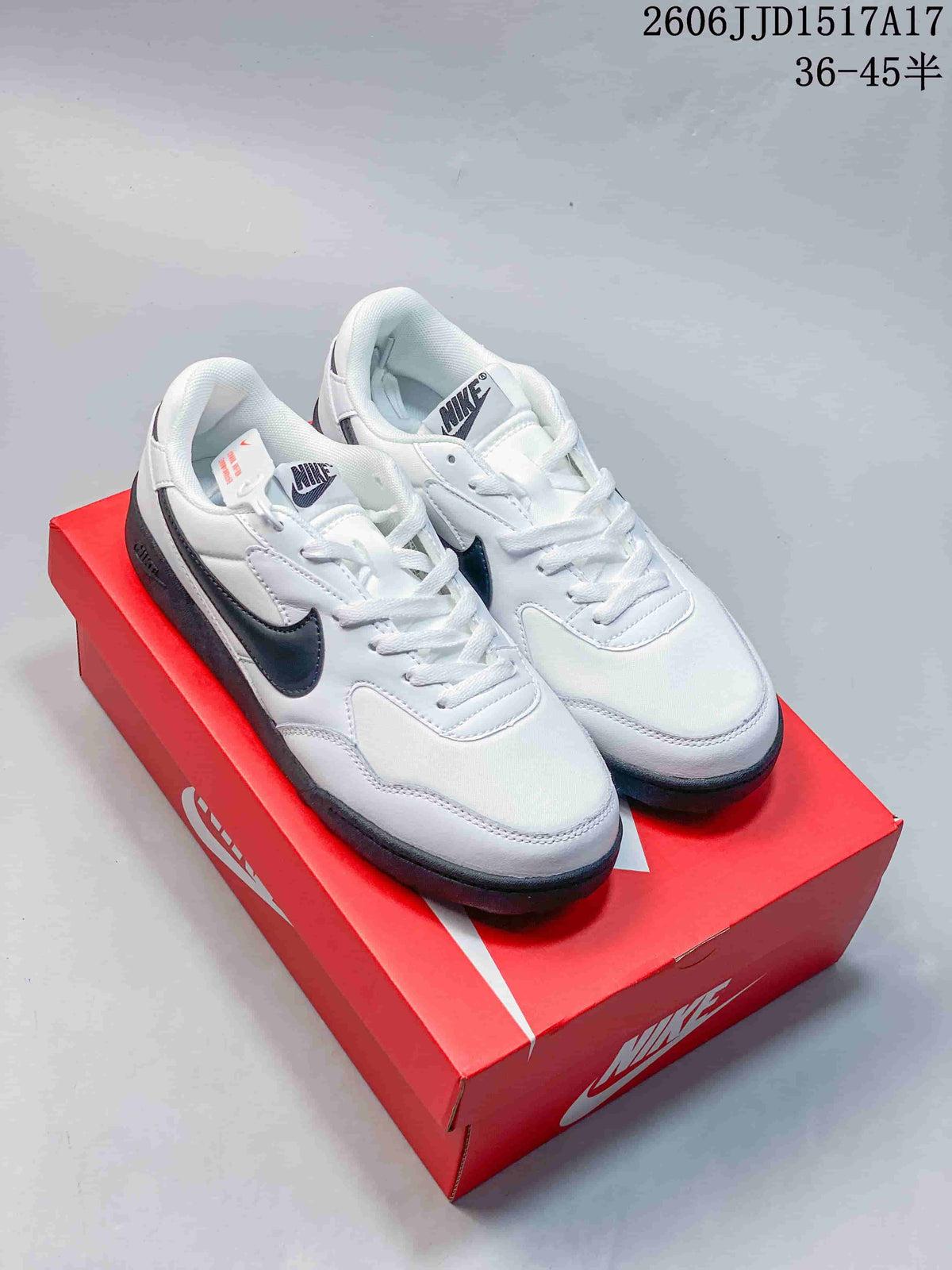 Pair of white Nike Terra Manta sneakers with dark gray accents, shown on a red shoe box.