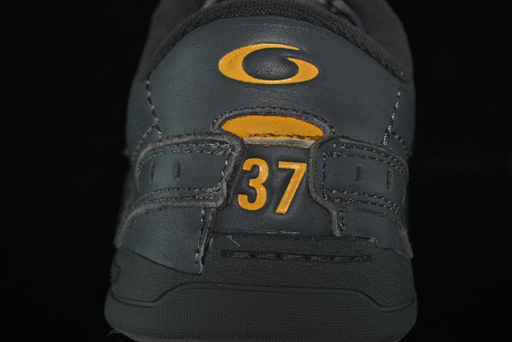 Rear view of sneaker with yellow-orange details and size 37 marking