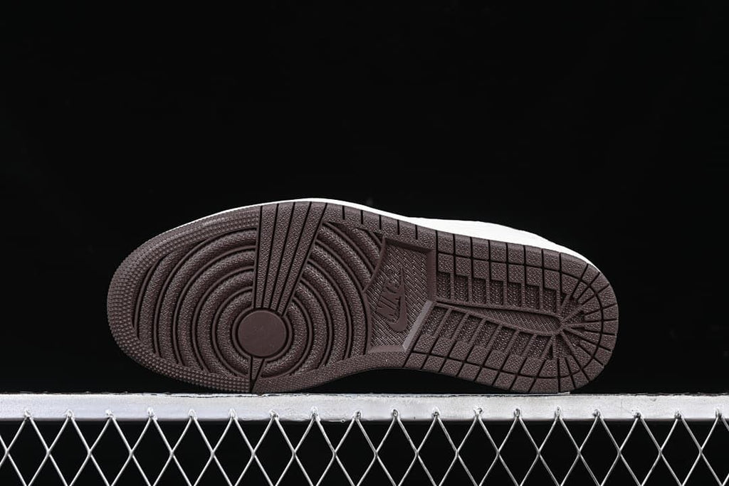 Underside view of the dark brown patterned outsole