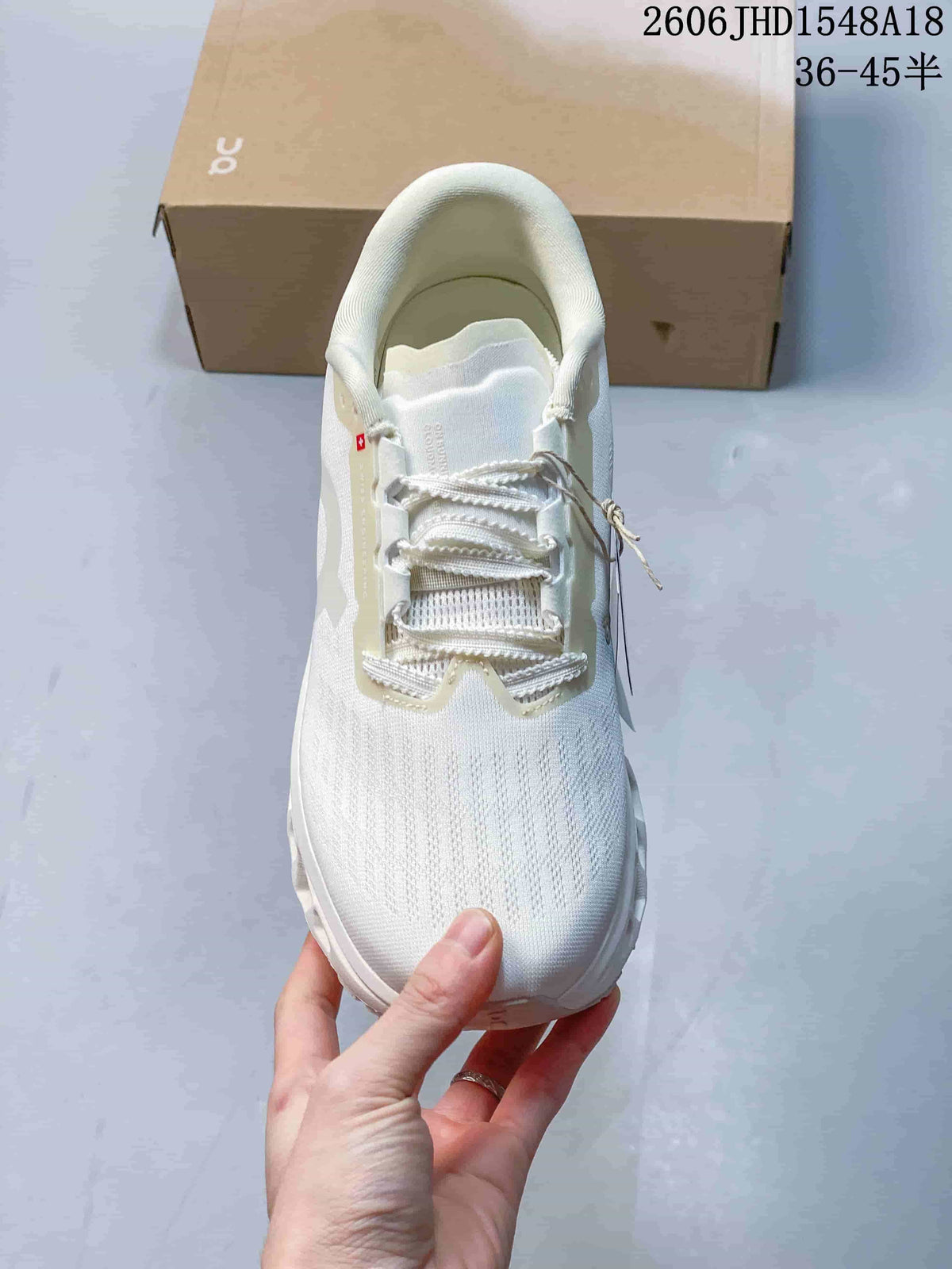 Top view of the white sneaker showing its laces and textured upper