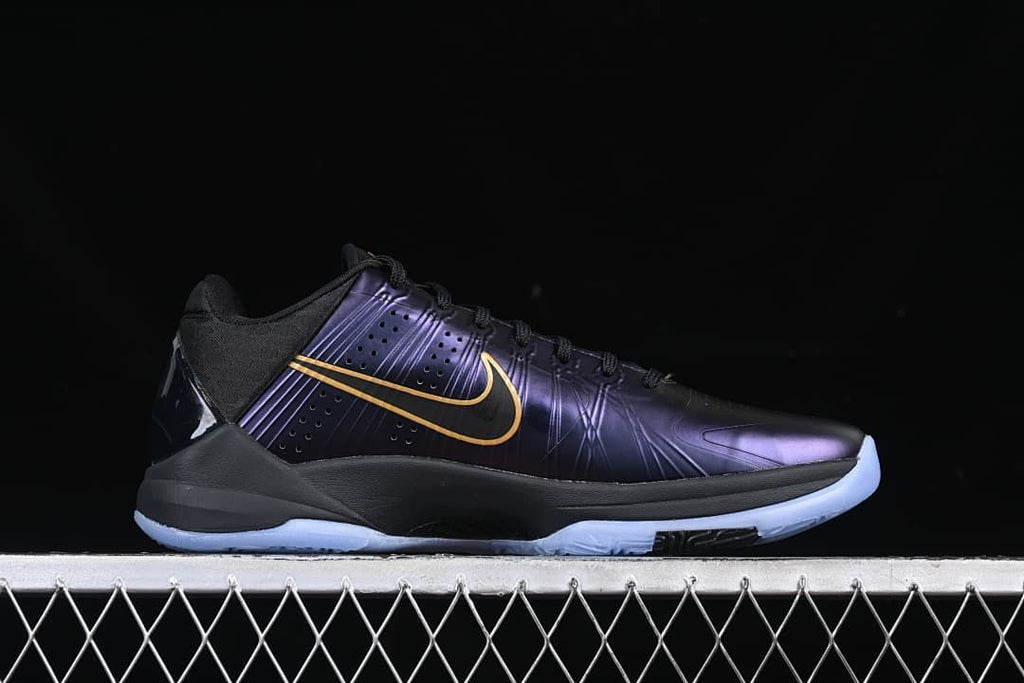 Side profile showing a purple upper, gold Swoosh detail, black midsole, and pale blue outsole