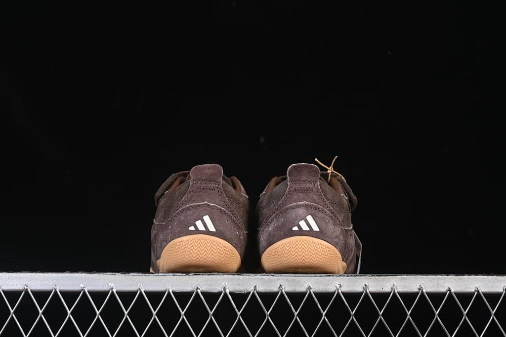 Rear view of both sneakers with gum-colored outsoles.
