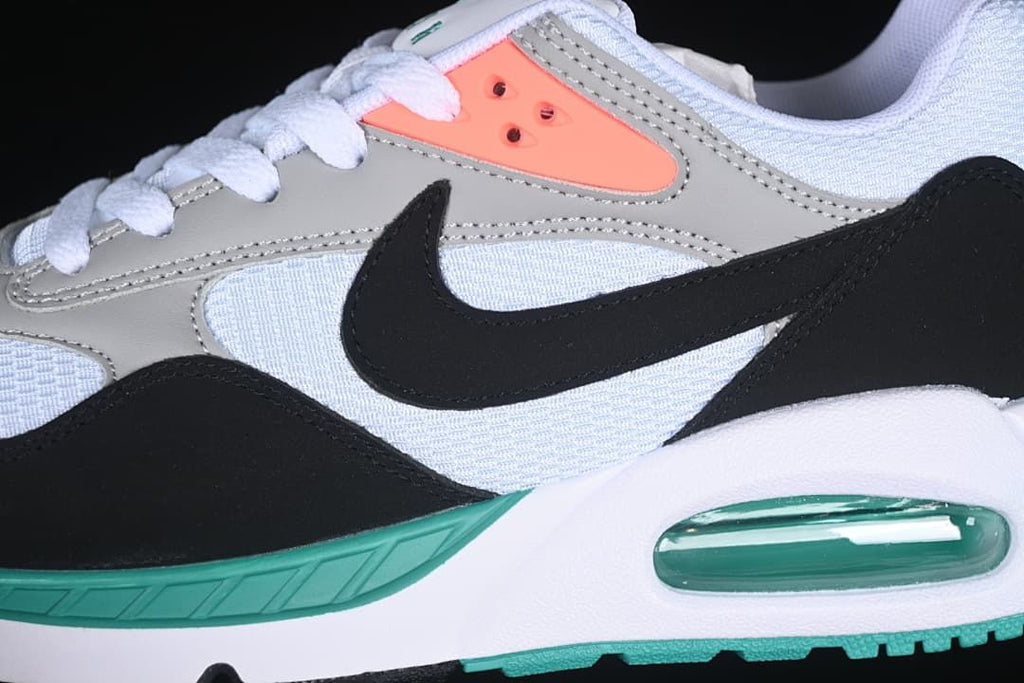 Close-up of the grey overlays, black Swoosh, coral eyelet panel, and teal midsole accent.