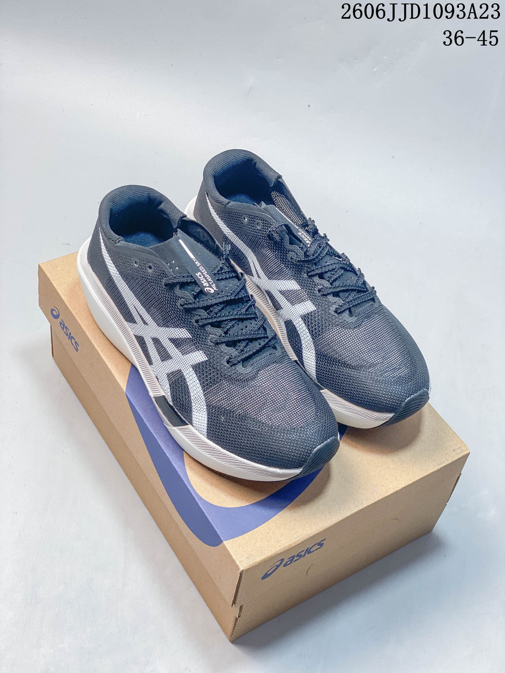 Pair of gray and white ASICS Metaspeed Sky Tokyo running shoes displayed on a shoebox.