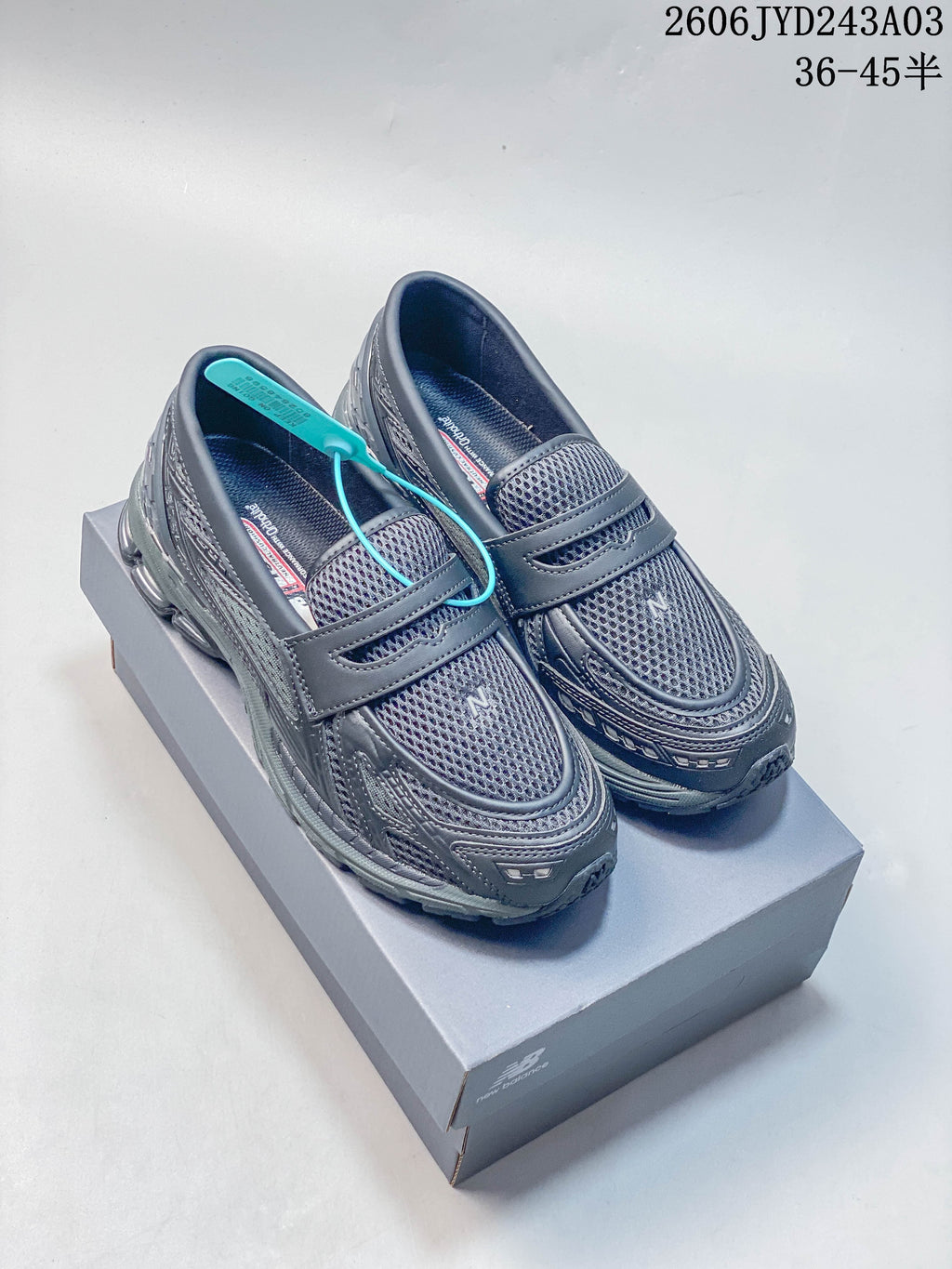 Pair of charcoal gray New Balance 1906L loafer-style sneakers shown from above at an angle