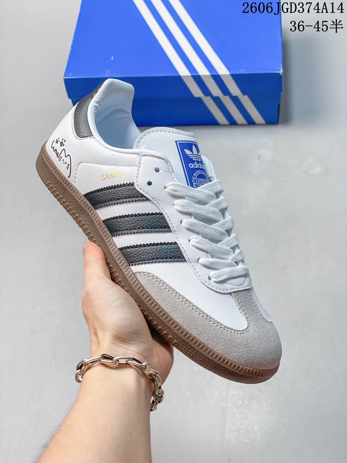 White low-top sneaker with dark stripes, pale toe overlay, gum sole, and decorative heel graphics.