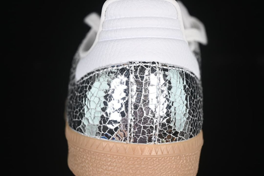 Rear view showing the reflective patterned heel panel and gum-colored outsole