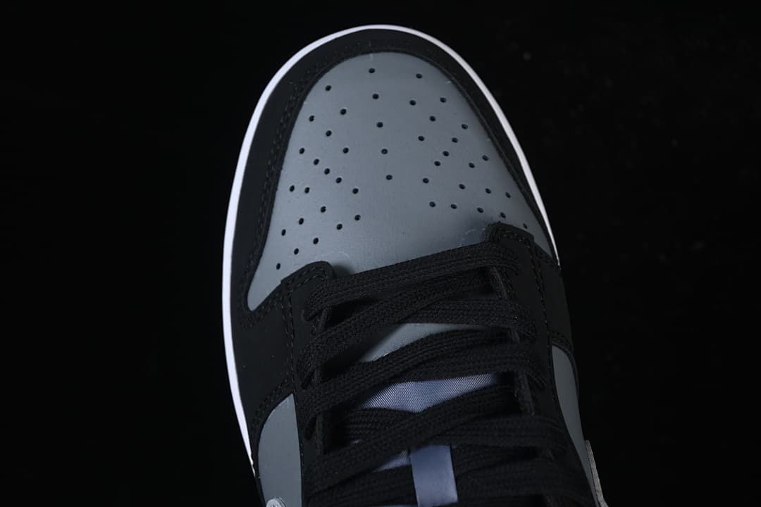 Top view of the perforated grey toe box and black laces