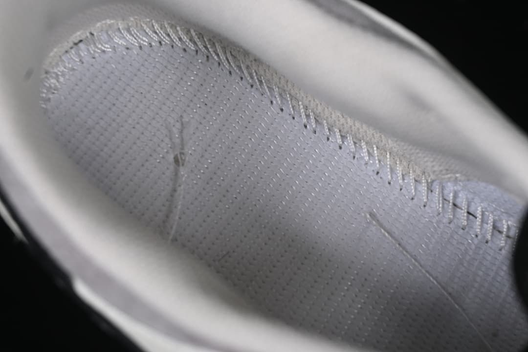 Close-up of the sneaker's light-colored inner lining and stitching