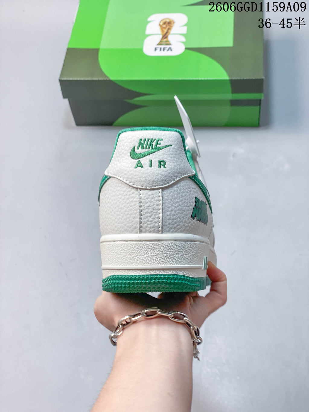 Rear view of a white sneaker with green outsole and Nike Air branding