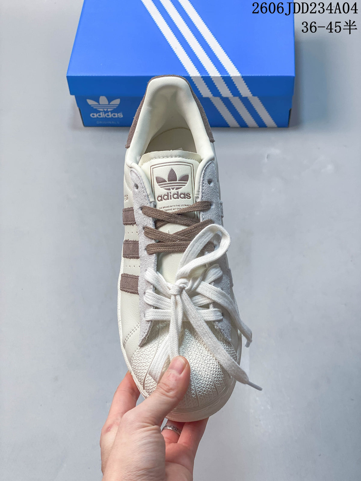Front view of an Adidas Superstar sneaker showing the lace-up design and shell toe.