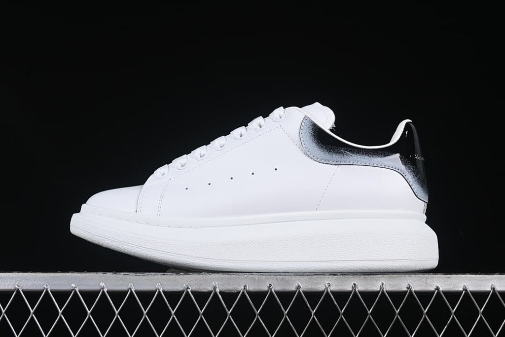 Side profile of the white sneaker with a gradient heel tab