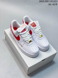 Pair of white low-top Nike Air Force 1 sneakers with red accents and gold-tone lace details