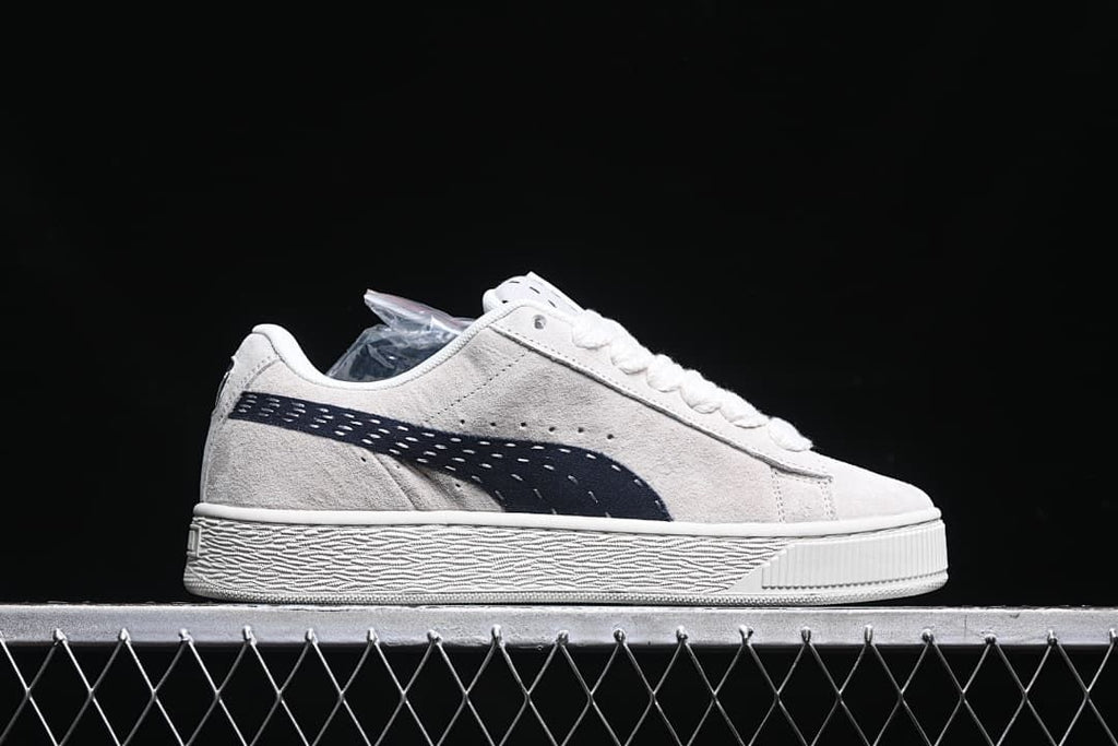 Side profile of the low-top sneaker with a dark navy side stripe.