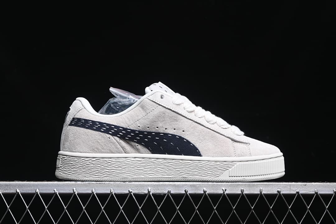 Side profile of the low-top sneaker with a dark navy side stripe.