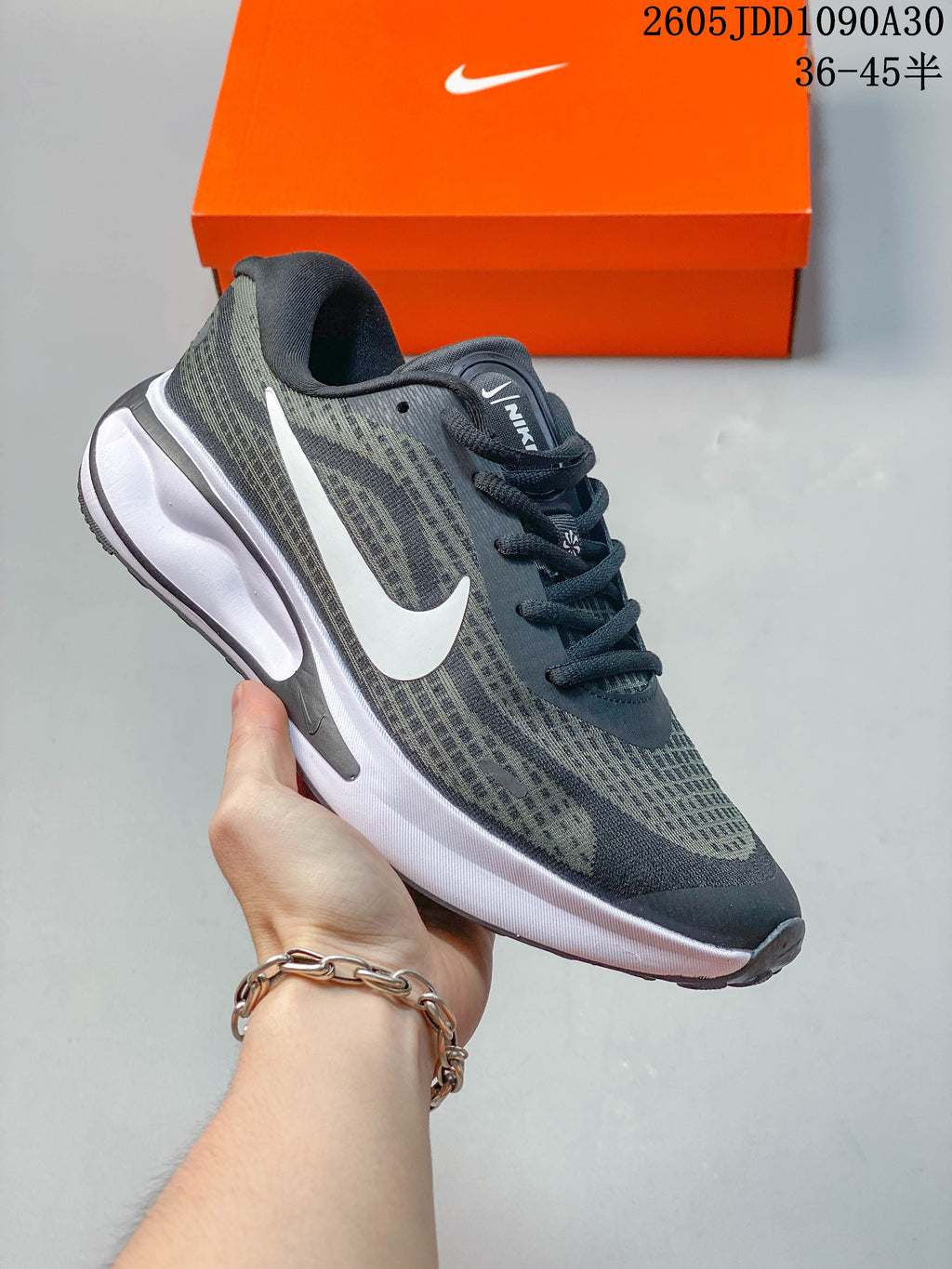 White Nike Journey Run running shoe with silver-gray accents and a patterned upper.