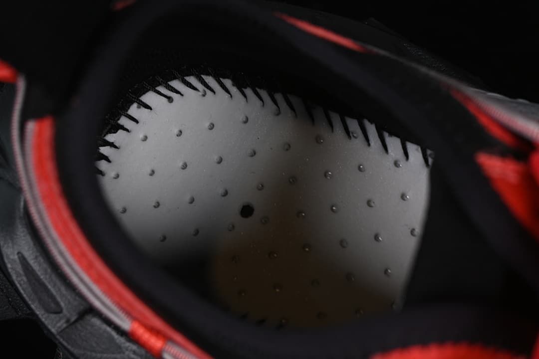 Close-up of the perforated insole inside the red and black sneaker