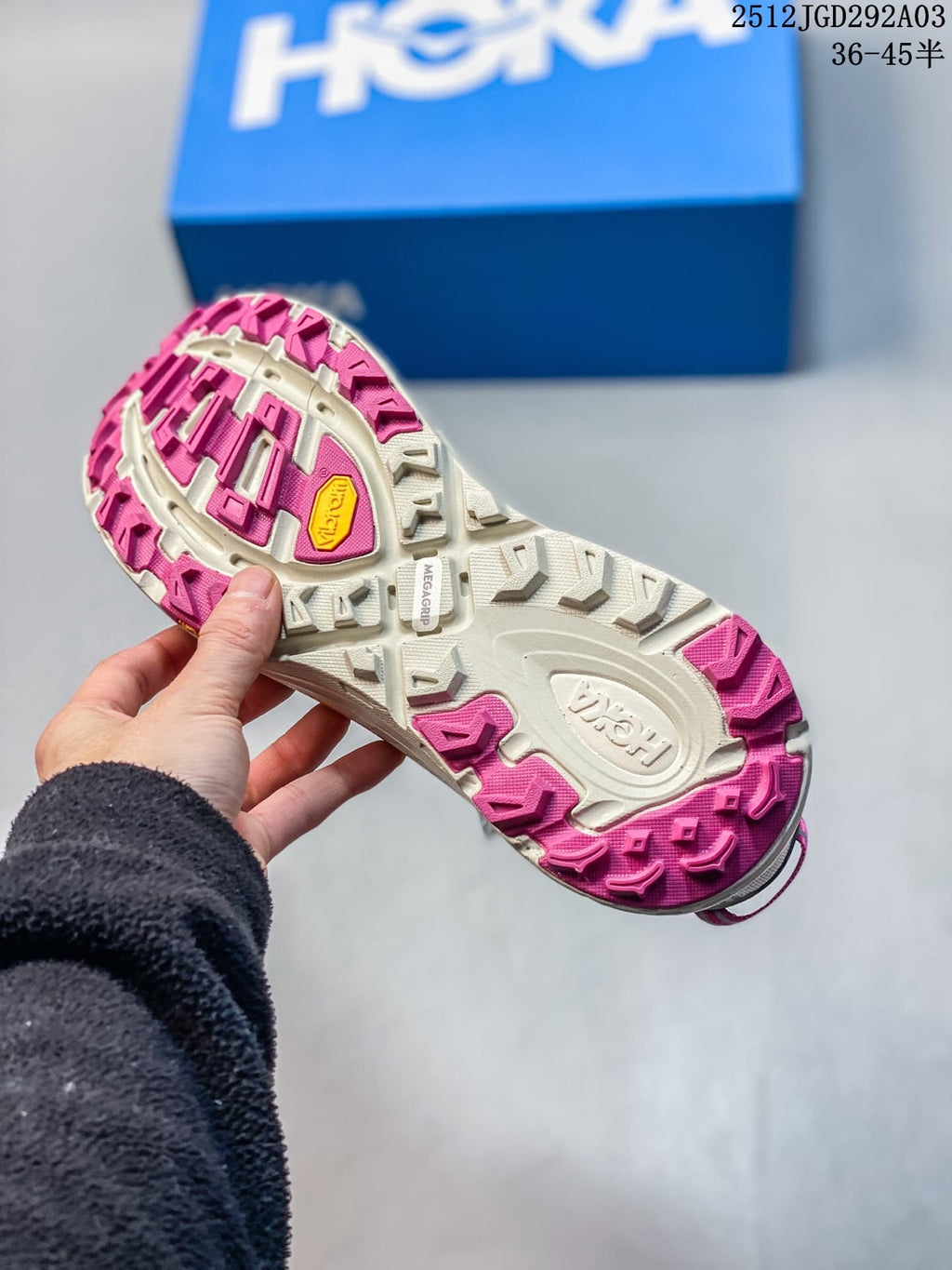 Underside view showing the cream and pink lugged outsole of a HOKA Mafate Speed 2 shoe.