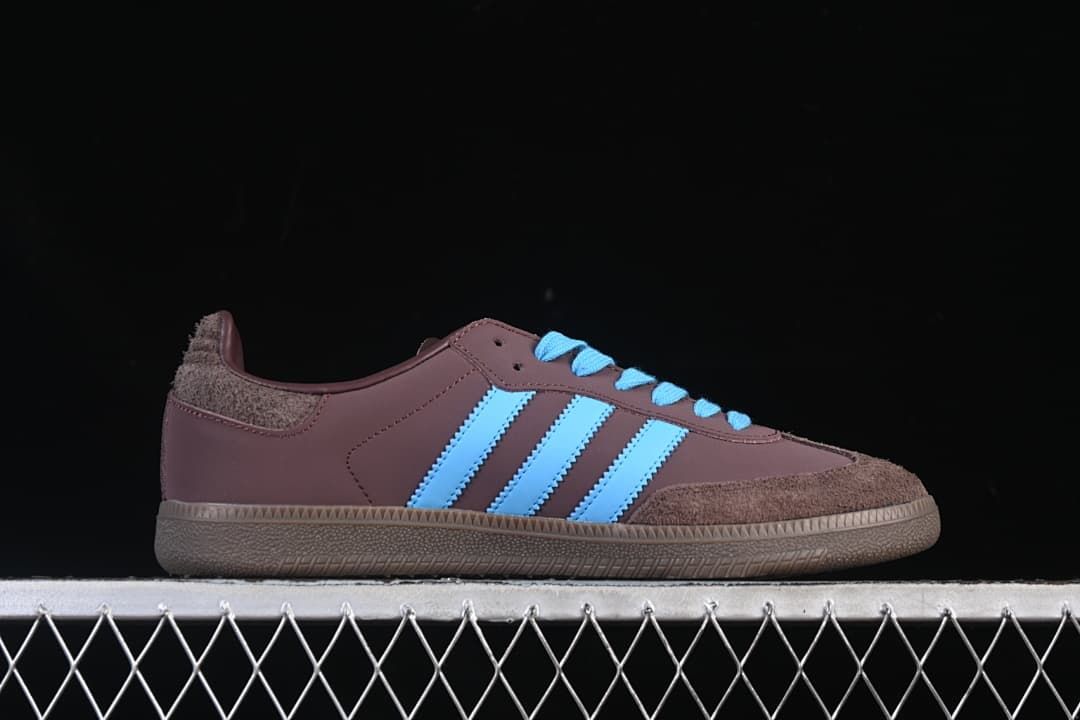 Side profile showing the brown upper, blue stripes, and brown outsole.