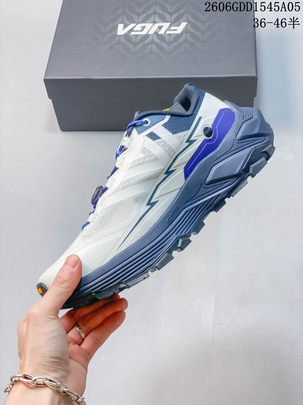 Side view of the low-cut trail shoe with dial-adjustable lacing.