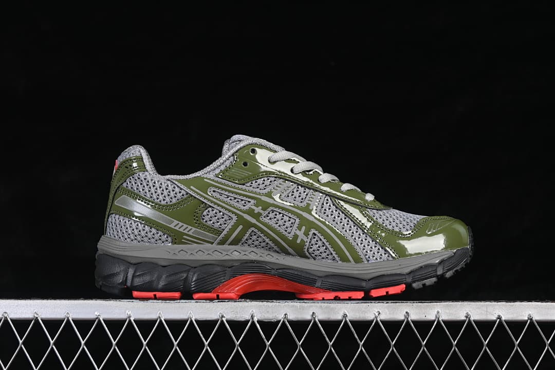 Side profile of the gray and olive-green sneaker with coral outsole accents.
