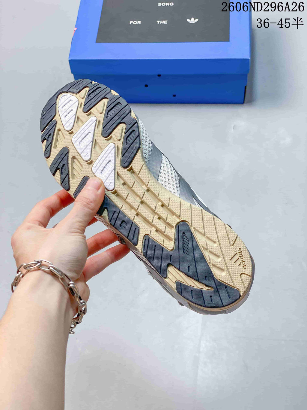 Close-up of the sneaker outsole with beige and dark contrasting sections
