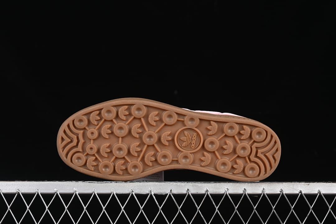 Underside view of the gum-colored outsole with circular tread details