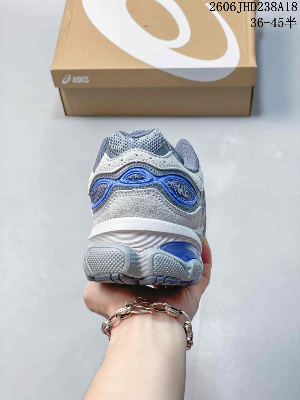Rear view of a grey sneaker with blue heel accents