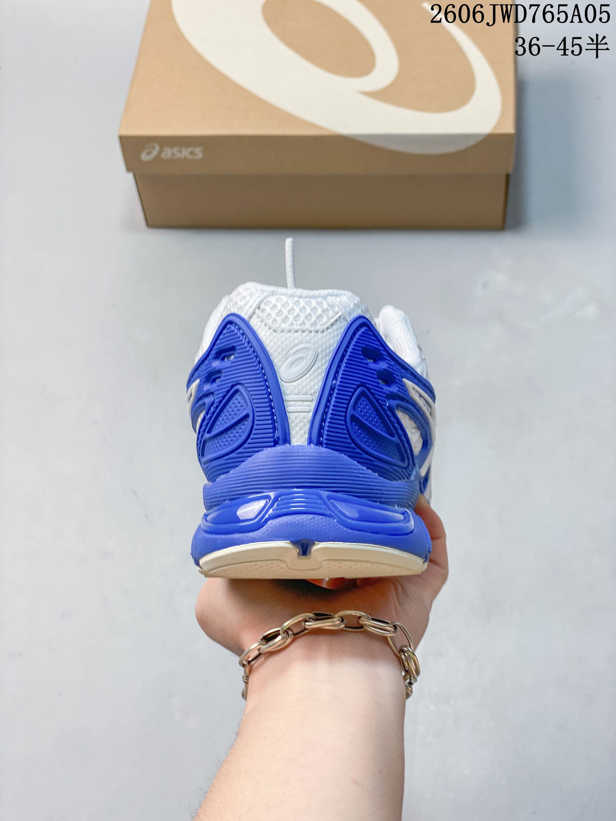 Rear view of a white and blue sneaker with a chunky blue heel.