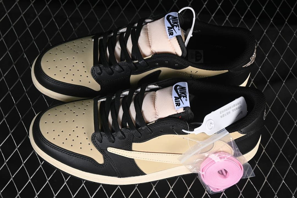 Pair of black and sail low-top sneakers with an additional pink lace set