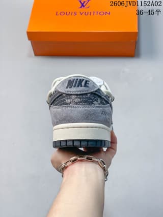 Rear view of the sneaker showing the gray heel panel, white midsole, dark outsole, and branded tongue detail.