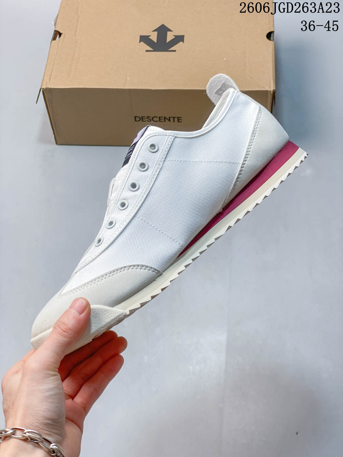 Side profile of the white sneaker with a contrasting heel stripe