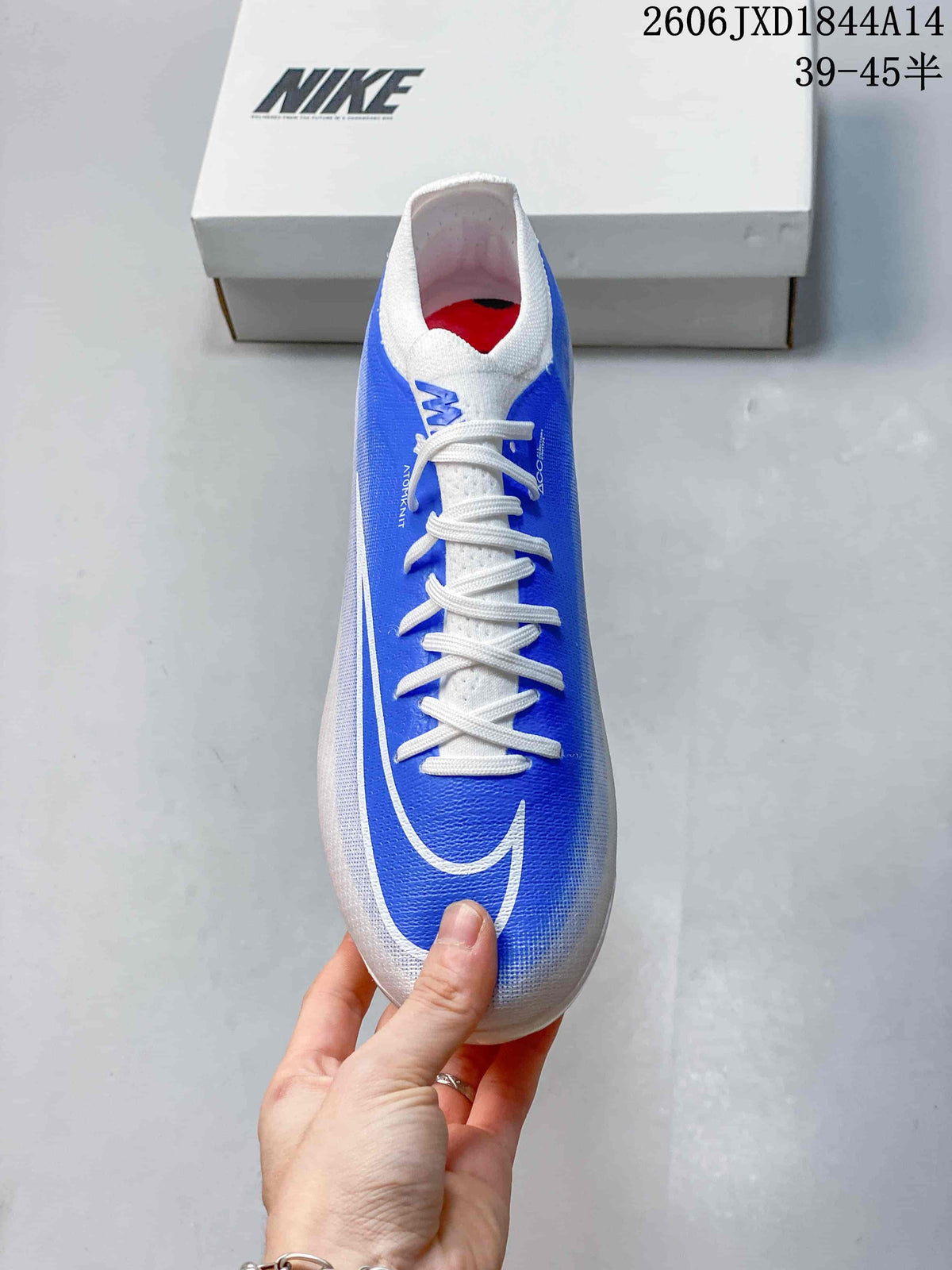 Top view of a blue-and-white Nike soccer cleat with white laces.