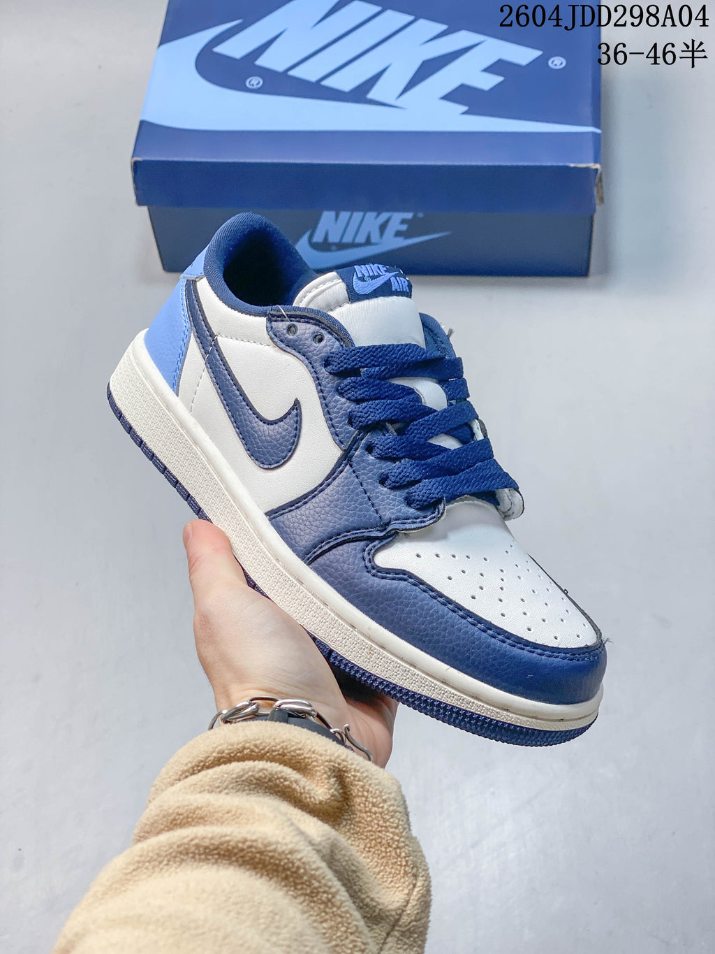 Angled view of the blue and white low-top sneaker