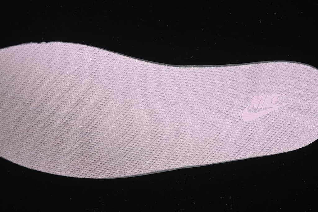 Close-up of a pink textured shoe insert with a visible Nike mark.